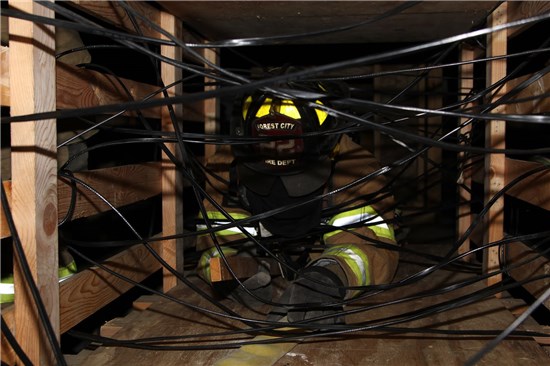 Firefighter Crawling Through Training Facility