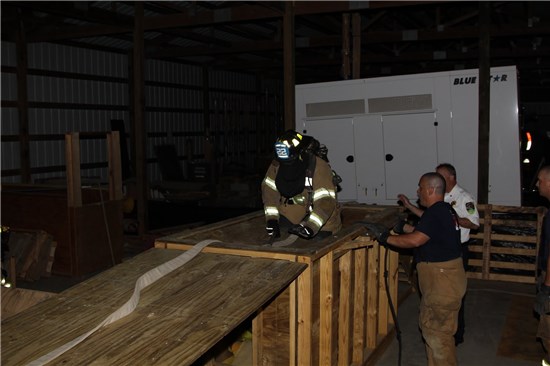 Firefighter Using Water Hose at Training Facility